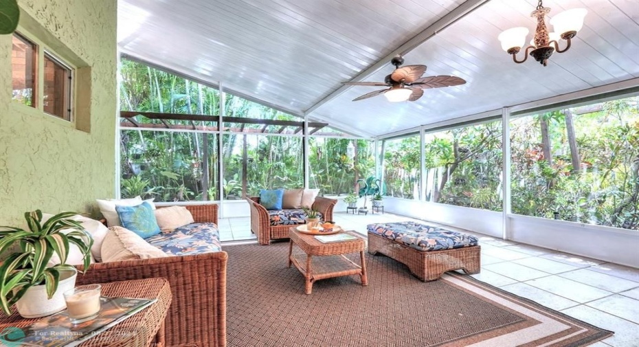 So much more than a patio, this area is like a Florida Room, with walls of screens, rare aluminum vaulted ceiling, ceiing fan, lights, fully tiled.