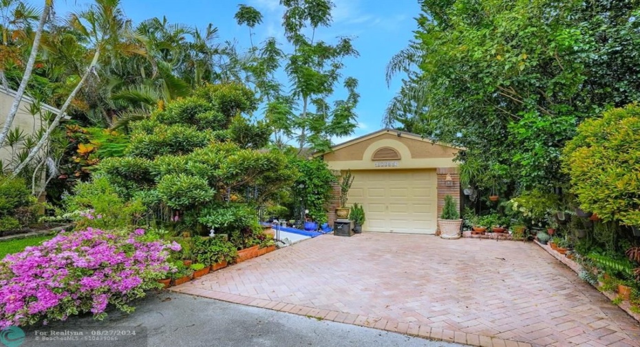 Spectacular curb appeal between the lush, colorful landscaping & the brick paver driveway,, rare in this neighborhood.