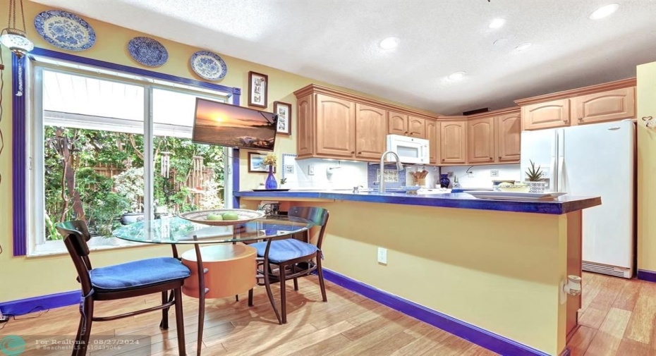 The colorful, cozy kitchen will make you feel like you're dining in Positano, with rich yellow & blue hues.