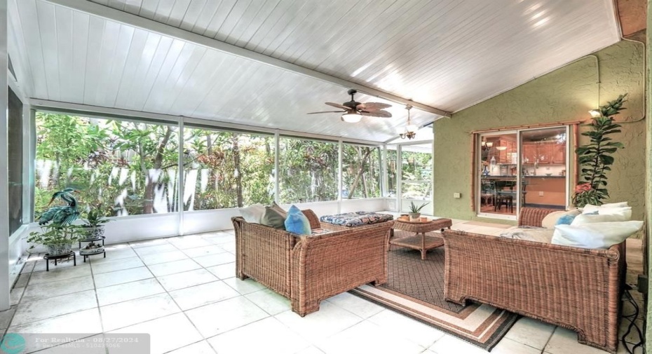 Fully tiled, and with ceiling fans, this 400sf patio/sunroom is one of the only homes in the neighorhood  to feature an aluminum ceiling!