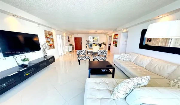 white leather sect sofa, Large Flat TV, upscale furnished
