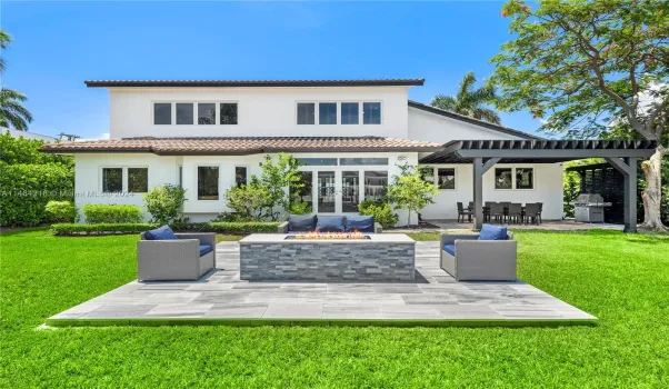 The backyard features a waterfront fire pit with a pergola, an entertainer's dream.