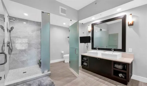 Master bathroom with double sink, separate shower, toilet and bathtub