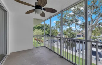 Enjoy the mature trees and water views from your back screened porch