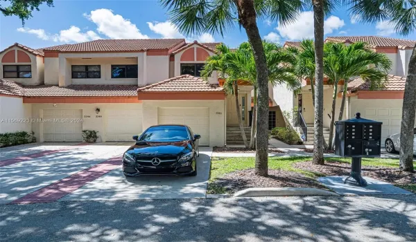 Driveway with garage and private entrance.