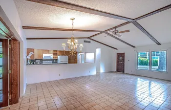 Ample space to transform this space into a complete open Kitchen, dining and living room. Love the vaulted ceilings!