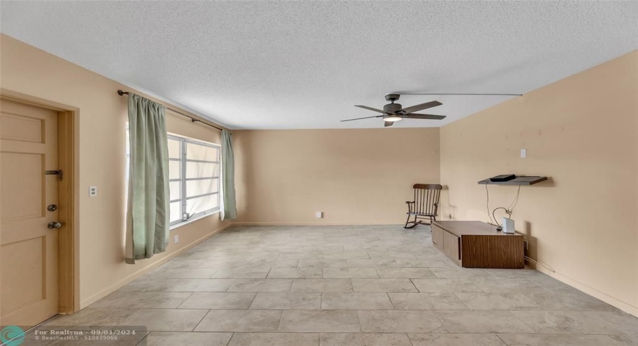 Large and spacious Living room with tile flooring and great natural light