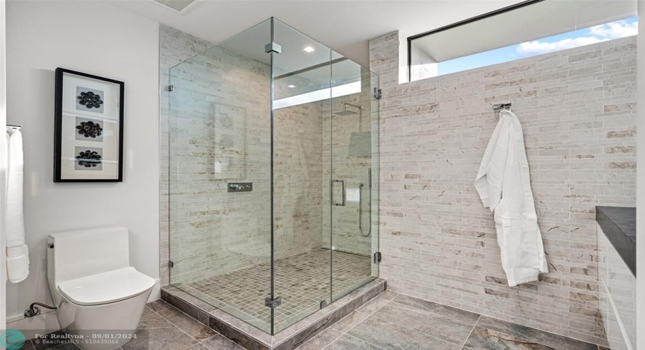 Bathroom and glass enclosed shower.