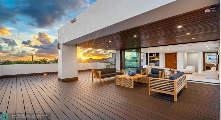 Outside sitting area on the third level with outdoor kitchen, jacuzzi, and firepit.