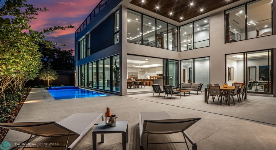 The backyard with outdoor kitchen and shower.