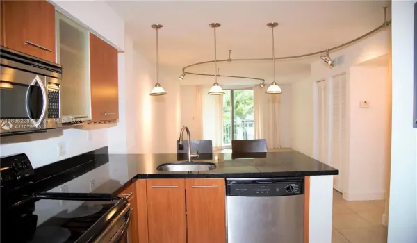 Open Layout Kitchen with Stainless appliances. Diswasher, Electric Stove, Microwave, Disposal, and lots of extra cabinetry.