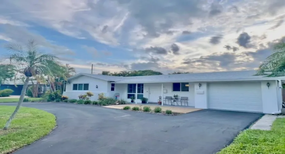 Front home facade with circular and straightaway drive (resurfaced), impact garage door, windows/doors, exterior paint, 2023 roof.