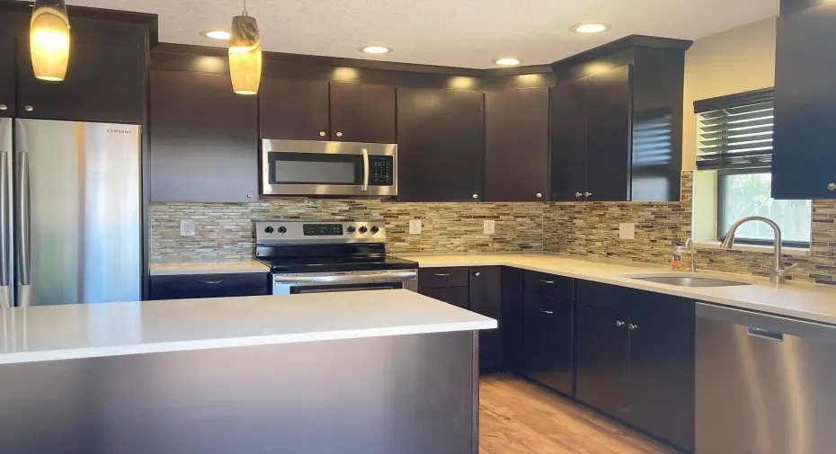 Nicely designed kitchen with gorgeous quartz counters, center island