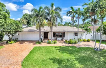 Beautifully landscaped large front yard on this 4 BEdroom / 4 bath home in Lighthouse Point