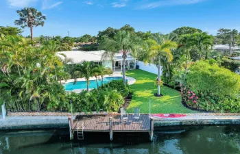 Huge backyard with heated saltwater pool, dock and fenced yard.