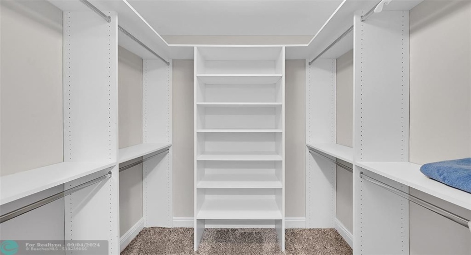 Organized walk-in closet in second bedroom suite.