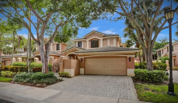 Picture perfect setting for this beautiful coach home with pvt elevator and full impact glass! Brick paver driveway, spacious 2 car garage with ramp to interior, hence ADA accessible.