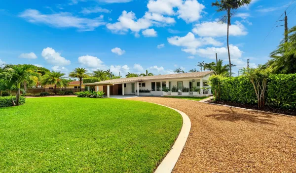 Front of property with meticulous landscaping.