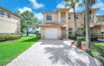 Front of property with private driveway.