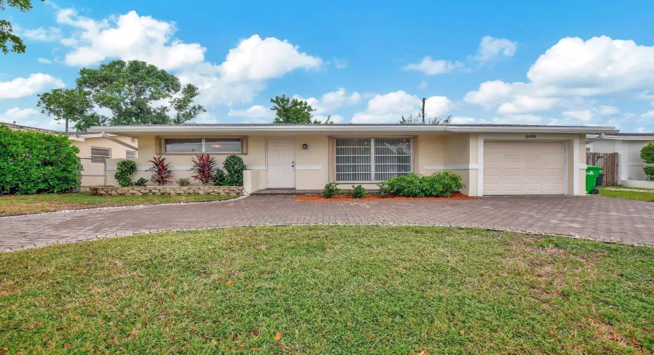 FRONT of home showcasing circular pavered driveway
