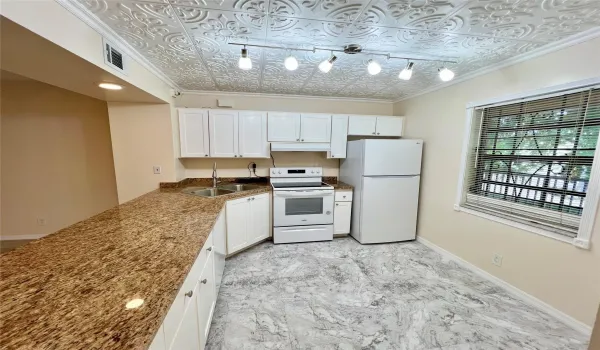 BEAUTIFUL KITCHEN WITH EXTENDED CABINETRY AND GRANITE COUNTERTOPS