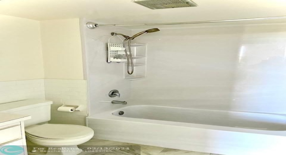 Primary bathroom with tub and shower combination