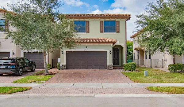 Front of home features 4 Car  - Brick Paver Driveway, and 2 Car Garage