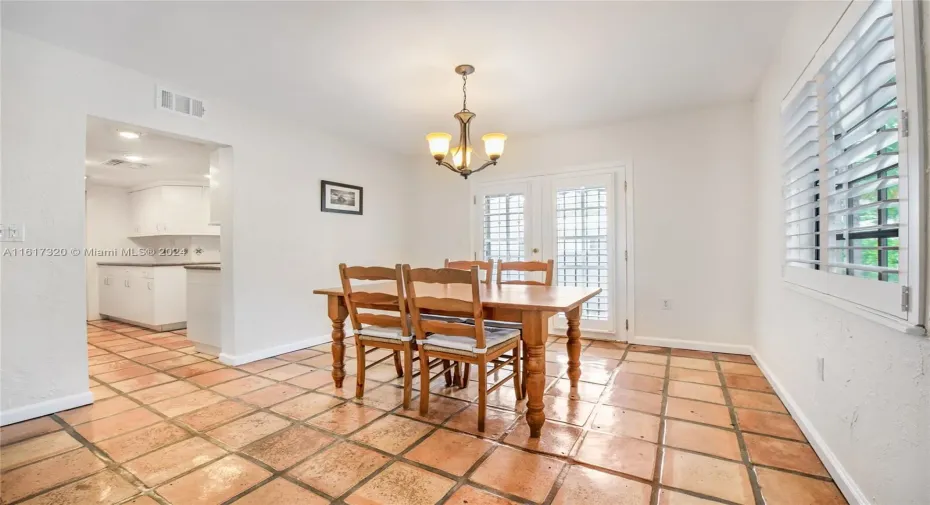 Elegant and formal dining room with access to kitchen, balcony and patio.