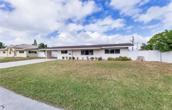 Kitchen is updated with white shaker cabinets, stainless appliances, granite counters, tile backsplash and great natural light