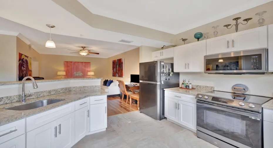 Fully renovated kitchen with balck stainless steel, granite, induction range