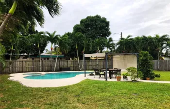 Inviting backyard with pool, jacuzzi, and dining/lounge area
