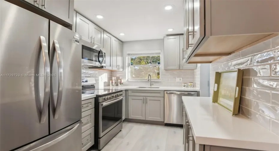 All new soft close cabinets, stainless steel appliances, tile backsplash
