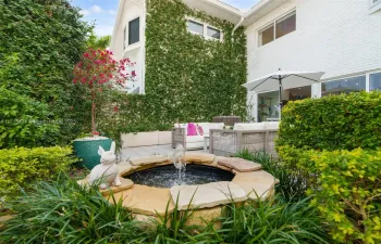 COURTYARD WITH MANICURED LANDSCAPING AND WATER FEATURE