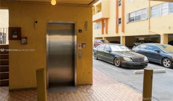 ELEVATOR ENTRANCE AT THE FRONT OF THE PARKING SPACE