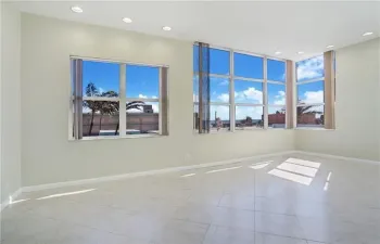 Spacious living dining area all tiled with impact windows