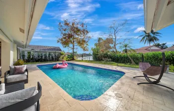 BRAND new pool deck with water view!  Overhang for table/chairs to entertain....