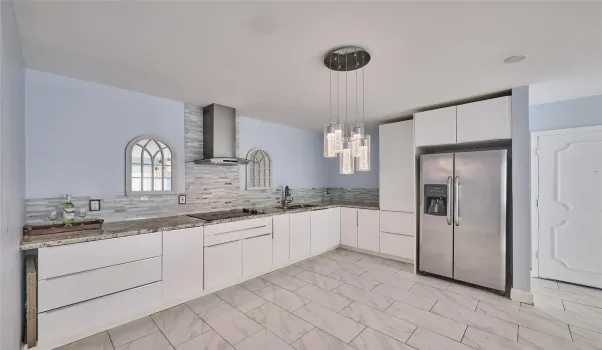 KITCHEN AREA SHOWING: GRANITE, WHITE CABINETS, STAINLESS STEEL APPLIANCES
