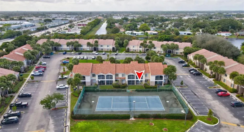 Aerial view of the rear of the unit with tennis court in the foreground.