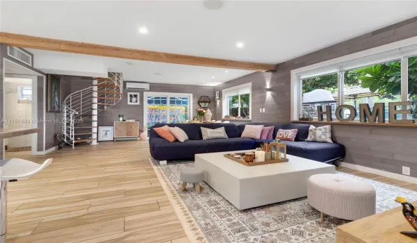 Spacious living space with recessed lighting & private garden views.