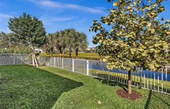 Peaceful fenced yard overlooking lake