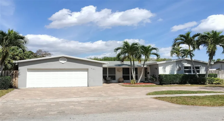 Southern exposure with new pavered circular driveway.