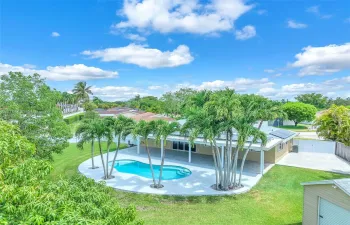 Beautiful oasis with a saltwater pool and a concrete slab behind gates for a boat/RV