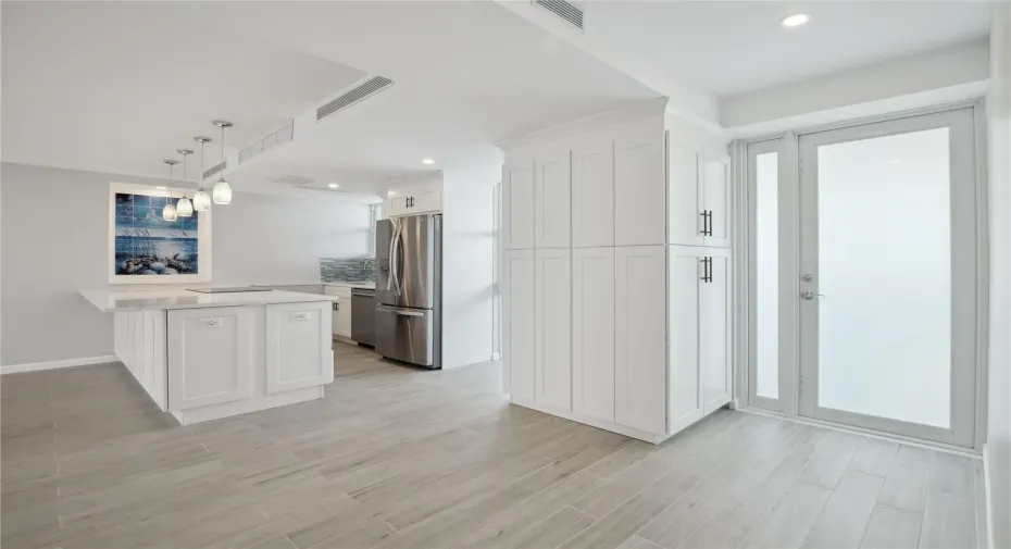 Vast quartz kitchen island, complemented by all-new soft-close cabinets, drawers, top-quality appliances and gorgeous views of the ocean and Lake Mayan.