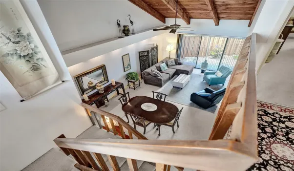 View of soaring ceiling overlooking living and dining area.