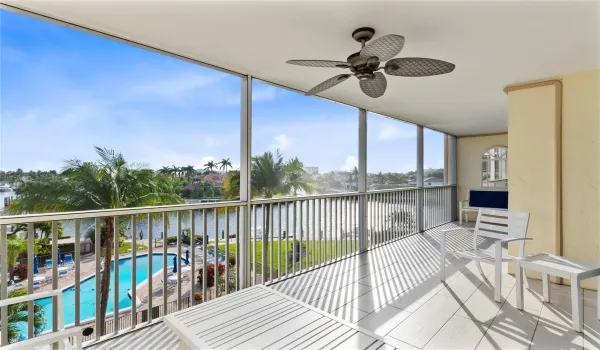 Expanded screened in patio overlooking the sparkling water and pool with access from the living room and primary bedroom.