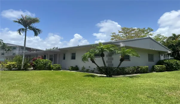 Quaint one story unit building within development of multiple floor buildings.