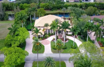 Grand circular driveway, porte-cochere entryway, situated on an oversized private acre-plus lot with waterfront along rear property line