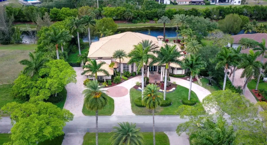 Grand circular driveway, porte-cochere entryway, situated on an oversized private acre-plus lot with waterfront along rear property line