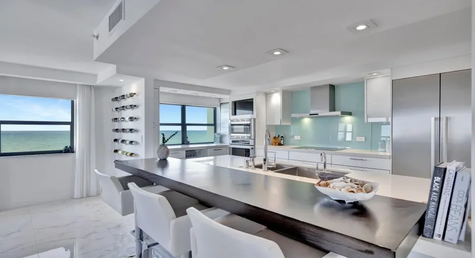 Kitchen with unique designer breakfast bar, wine wall, and coffee and wine bar