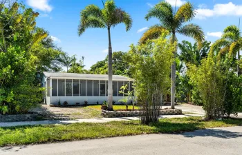 stylish dining and lounge furniture, all nestled within lush tropical landscaping. Perfect for enjoying the outdoors in sunny Fort Lauderdale!
